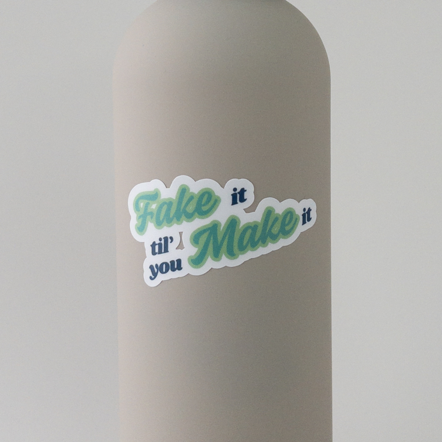 fake it 'til you make it vinyl sticker in green on water bottle